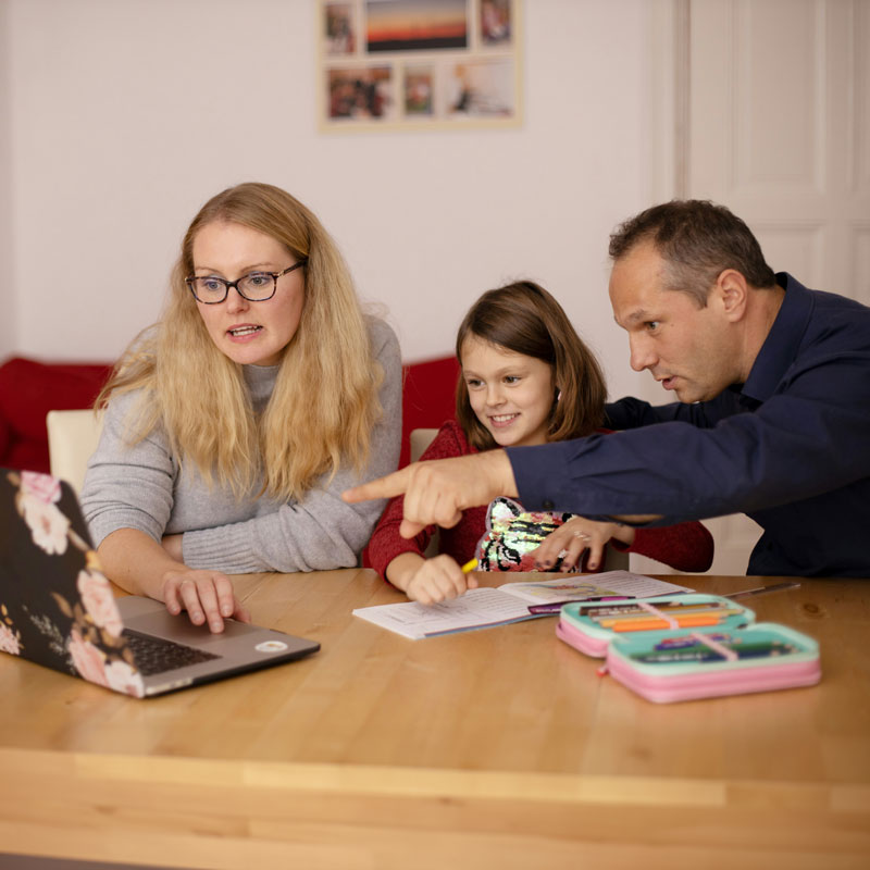 Homeschoolers with parents at computer